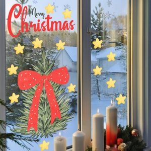 Close-up of Christmas tree window decals with red bow and Merry Christmas text
