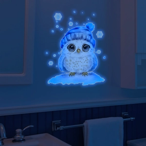 Glow-in-the-dark cute owl wall sticker with snowflakes in a dark bathroom setting