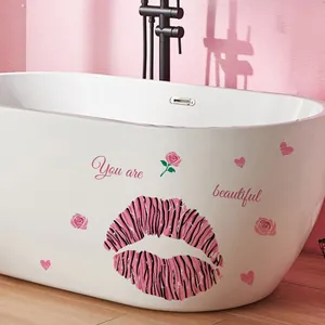 Detail of pink leopard lips and rose wall stickers on a white bathtub surface