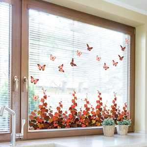 Detail of fall window clings with orange butterflies and autumn vine leaves decoration