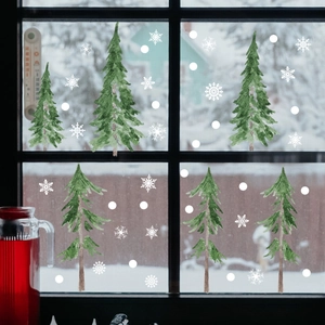 Detail of Christmas tree window stickers with snowflakes in a cozy snowy scene