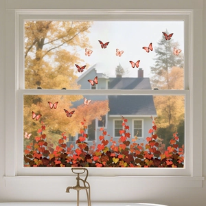 Detail of autumn window stickers with orange maple leaves and colorful butterflies