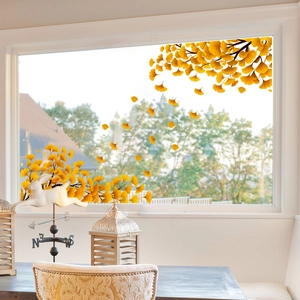 Detailed view of yellow ginkgo leaf window clings on bright glass with autumn vibes