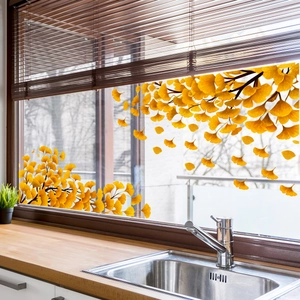 Vibrant yellow autumn ginkgo leaves window sticker in a bright kitchen setting