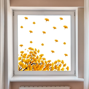 Detail of golden ginkgo leaf window stickers on a bright glass panel for autumn decor