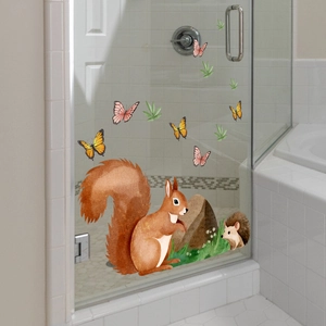Detail view of watercolor squirrel and hedgehog static cling decals on a glass door