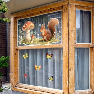 Detail of squirrel, red mushrooms and butterfly static window clings on glass