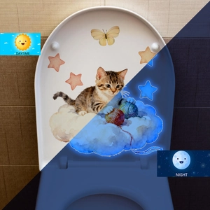 Luminous toilet sticker showing daytime watercolor cat and night blue glow effect