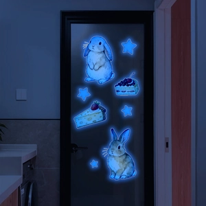 Glow-in-the-dark wall stickers featuring blue fluorescent rabbits, cakes, and stars