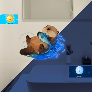Glow in the dark wall sticker showing day and night effect of a cute cartoon sea otter