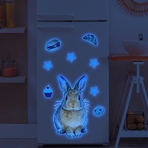 Luminous wall decals featuring a rabbit, stars, and food glowing in bright blue light