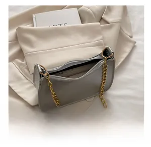 Detail view of the silver chain bag showing internal capacity with a smartphone