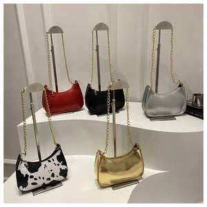 Five crescent shoulder bags in red, black, gold, silver, and cow print with chain straps