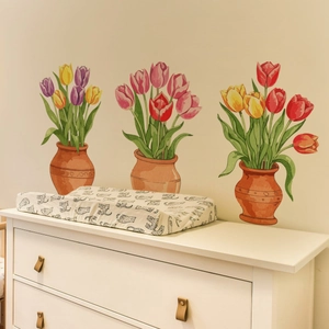 Soft leopard print changing pad cover on dresser with warm tulip wall decor background