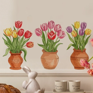 Close-up of three watercolor tulip flower pot wall decals on a light-colored wall surface