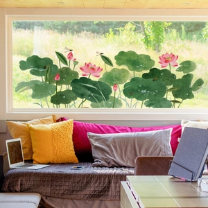 Pink lotus flower and dragonfly static window decals shown on a large sunlit pane
