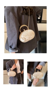 Detail of elegant beige lace evening clutch with floral embroidery and pearl clasp