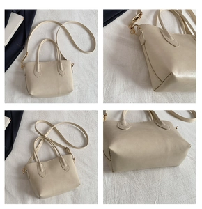 Détails du sac cabas blanc crème montrant les bandoulières, dorures et texture du cuir