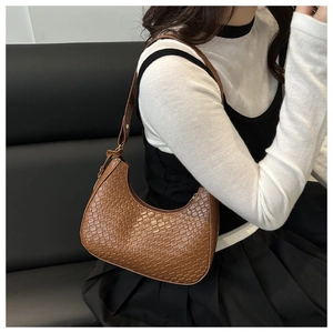 Detail shot of brown hobo bag showing the crocodile texture and adjustable strap