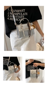 Silver structured crossbody bag with gold FASHION text and baseball sports keychain