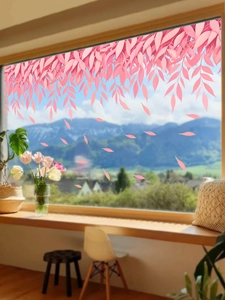 Detail of pink willow leaf static cling stickers on a window with a mountain view
