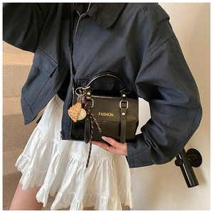 Fashionable black patent leather square crossbody bag with gold lettering and baseball charm