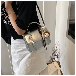 Silver metallic crossbody bag featuring Fashion lettering and baseball charm detail