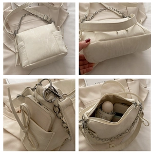 Detail view of cream butterfly crossbody bag featuring crackle texture and large capacity