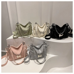 Detail of five-color pleated handbags with metal chains and butterfly pendants on display