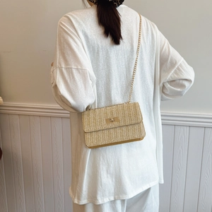 Straw weave chain crossbody bag with golden square lock and minimalist texture