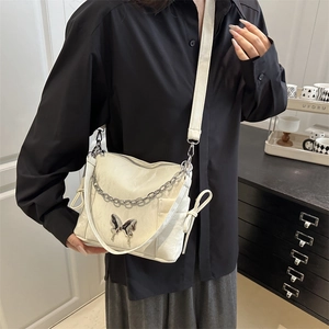 Fashionable cream bow shoulder bag with silver chain and bow knot side details