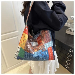 Detail of colorful patchwork tote bag with geometric patterns and shoulder strap