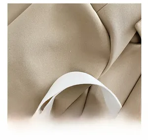 Detailed close-up of khaki canvas tote bag with thick woven shoulder strap and fine texture