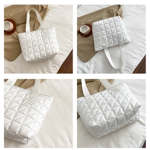 Detail view of white quilted tote bag featuring classic diamond stitch and plush texture