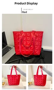 Detail of red quilted tote bag with diamond pattern stitching and large capacity