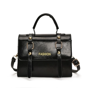 Glossy black vintage crossbody square bag with gold studs and top handle strap