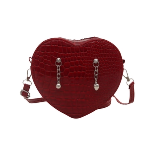 Classic heart-shaped red crossbody bag with crocodile pattern and silver chain detail