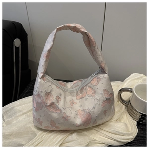 Close-up of pink butterfly embroidery and silver metallic thread on white hobo bag
