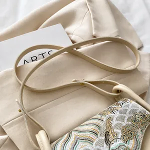 Detail of premium brocade fabric and soft leather strap on ethnic style crossbody bag