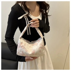 Detail of trendy jacquard butterfly pattern handbag with sparkling pink accents for women
