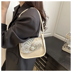 Detail of cream leather shoulder bag with Chinese embroidery showing wave patterns