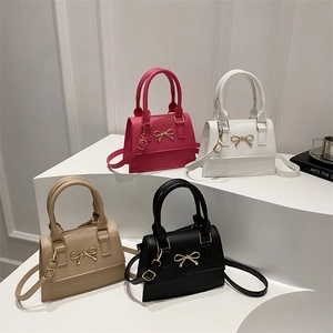 French design crossbody bag with bow hardware in fuchsia white beige and black
