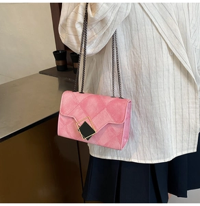 Gros plan sur le sac bandoulière rose matelassé avec chaîne et boucle luxueuse