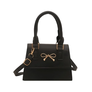 French style black handbag with golden bow detail and adjustable shoulder strap