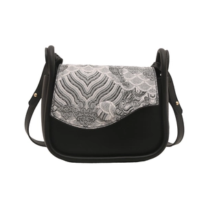 Minimalist black saddle bag with traditional Chinese wave jacquard pattern and strap