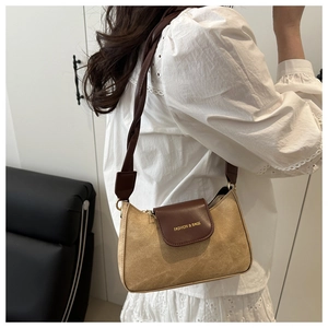 Detail of vintage saddle bag with khaki suede, contrast brown leather, and woven strap