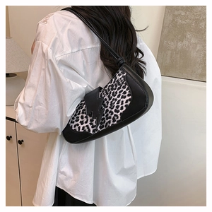 Side view of leopard print baguette bag on model showing size and y2k streetwear style