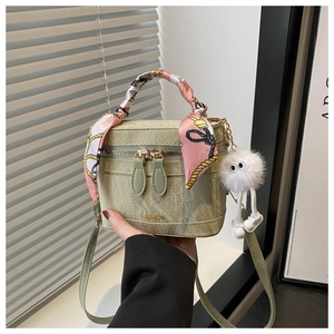 Close-up of green marble pattern box bag with floral silk scarf and plush charm detail