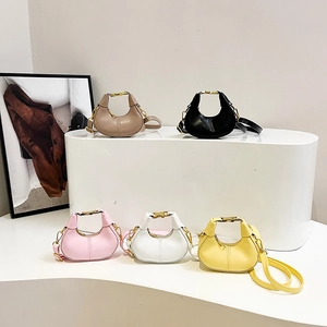 Collection of half-moon leather handbags with gold metal handles in five various colors