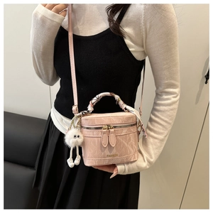 Pink box handbag featuring marble texture, silk scarf handle, and plush doll detail